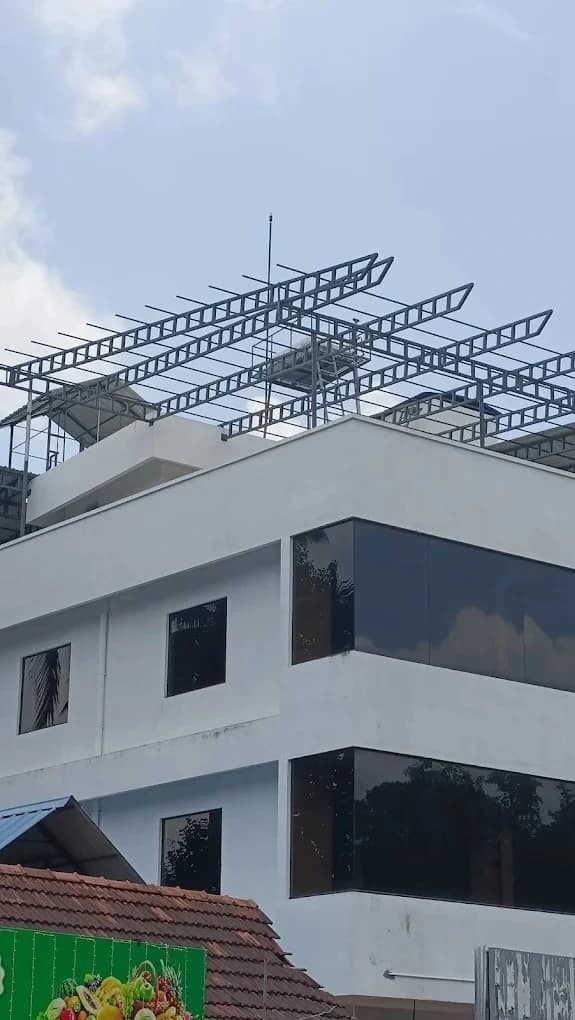 Stainless steel air-termination mast installed on industrial roof apex