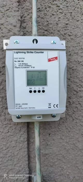 Conductor fastened with non-corrosive metallic clips down reinforced concrete pillar
